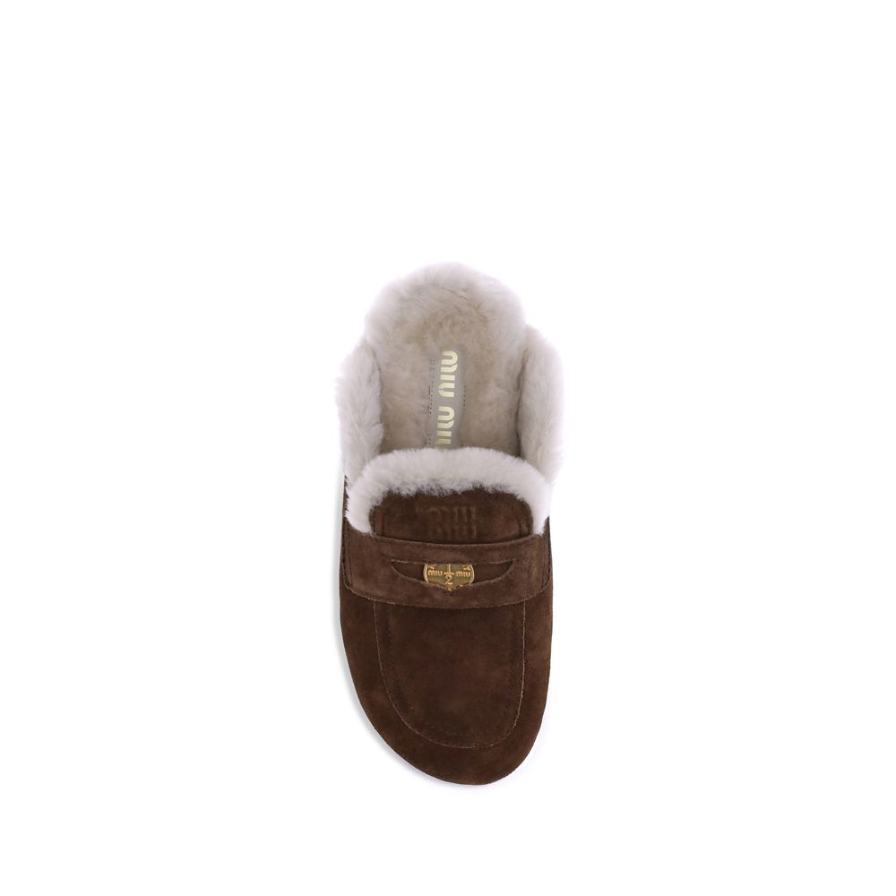 Mules en peau lainée Miu Miu